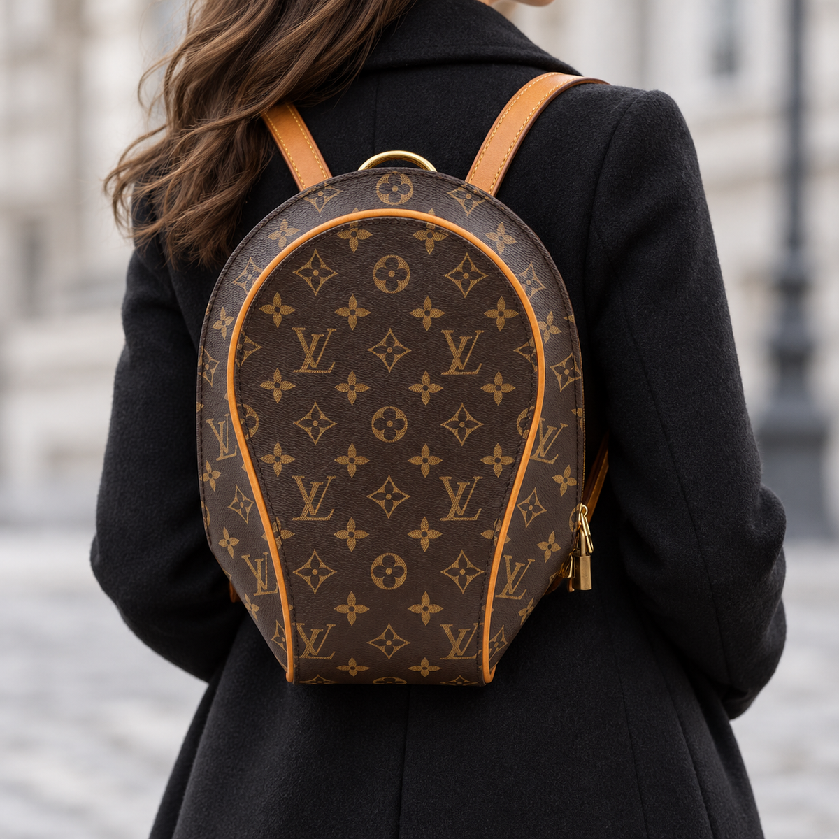 Louis Vuitton Ellipse monogram backpack styled with a black coat