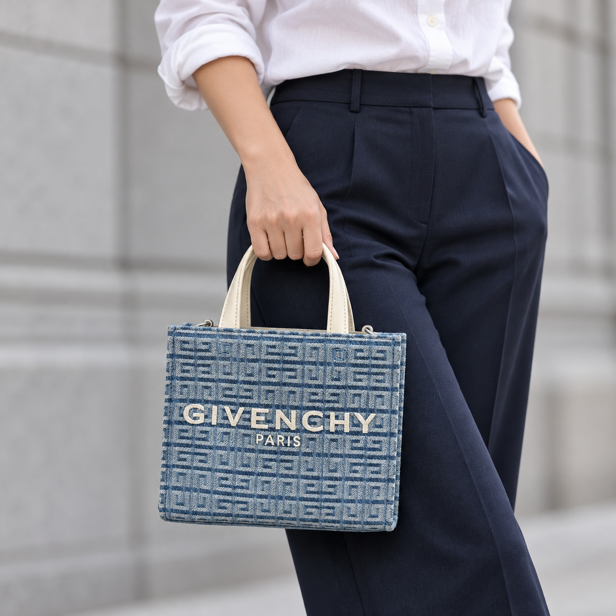 Givenchy G Tote mini carried with a white shirt and navy trousers